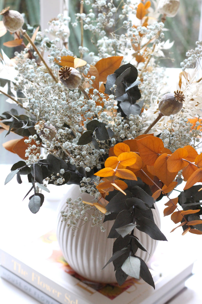 Flowers in darker shades in light brown ceramic