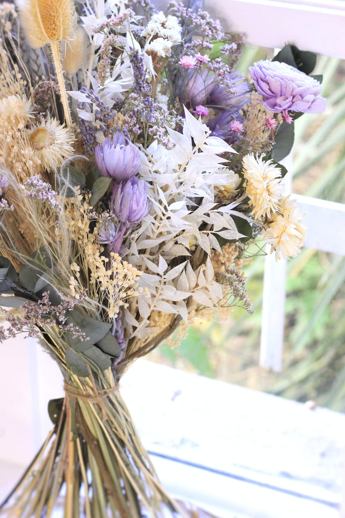 colorful dried flower bouquet laying on a bench