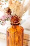 Small ribbed glass vase with dried flowers 