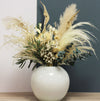 Dried flower tall arrangement with pampas grasses and eucalyptus in opaque white vase