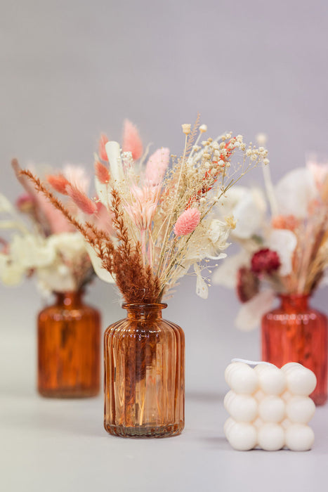 Small ribbed glass vase with dried flowers 