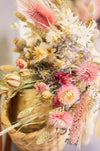 Close up of dried flower bouquet in pink, natural, and green shades