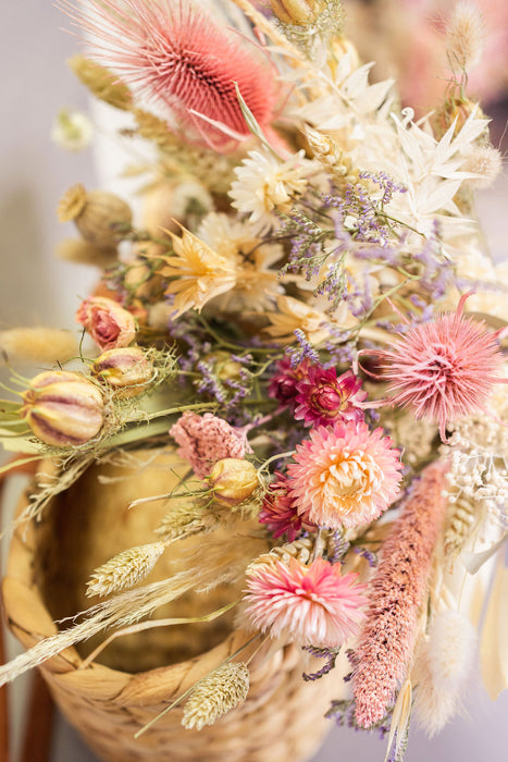 Close up of dried flower bouquet in pink, natural, and green shades