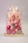 Dried flowers design in glass dome with preserved rose and preserved moss