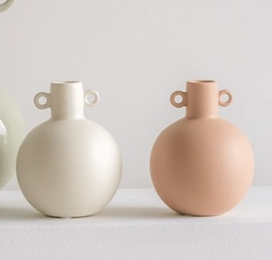 small stoneware opaque white and cameo brow vases against neutral background